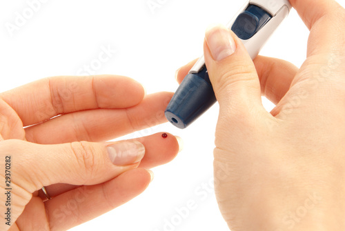 Photo: Lancet in hand prick finger for blood glucose level Lancet in hand prick finger for blood glucose level