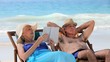 Aged couple relaxing on beach chairs