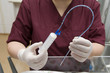 Photo: Nurse prepares a syringe for feeding premature child Nurse prepares a syringe for feeding premature child