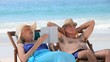 Elderly couple relaxing on beach chairs