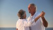 Aged couple dancing together