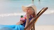 Elderly woman sipping a cocktail