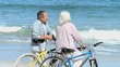 Elderly man talking with his wife after a bike ride