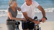 Aged couple with bikes talking each other