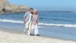 Video: Elderly couple walking along the beach Elderly couple walking along the beach