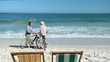 Elderly couple with bikes talking 