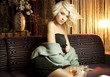 Beautiful sexy blond girl sitting on the couch and posing Beautiful sexy blond girl sitting on the couch and posing