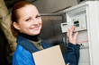 cheerful woman engineer in a boiler room