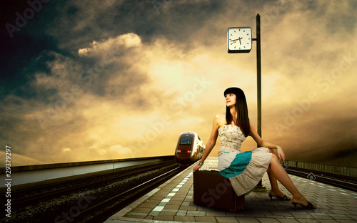 Photo: Girl waiting train on the platform of railway station Girl waiting train on the platform of railway station
