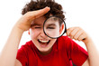 Boy looking through magnifying glass isolated on white Boy looking through magnifying glass isolated on white