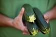A man holding courgettes
