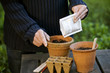 A man planting seeds in a pot