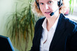 Foto: Closeup of a business woman with laptop and headset Closeup of a business woman with laptop and headset