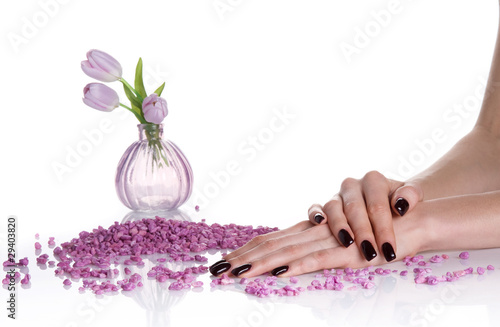 Photo: Dark mancure, spa stones and lilac vase with tulips Dark mancure, spa stones and lilac vase with tulips