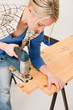 Home improvement - handywoman cutting wooden floor