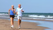 Jogging Seniors in Sportswear on the Beach filmed at 60FPS