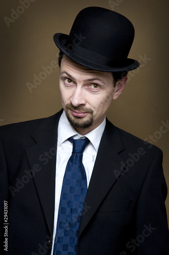 Photo: looking from businessman with bowler looking from businessman with bowler