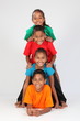 Cheerful school friends form human totem-pole