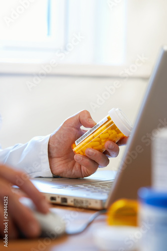 Photo: Doctor preparing online internet prescription drugs Doctor preparing online internet prescription drugs