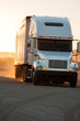 Tractor-trailer in sunset near American interstate I-40