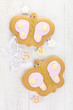 batterfly ginger cookies with sugar flowers on white table batterfly ginger cookies with sugar flowers on white table