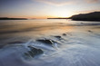 waves rolling on beach at twilight