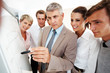 Senior manager explaning business graph to his coworkers Senior manager explaning business graph to his coworkers