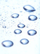 Large and fine water drops on glass