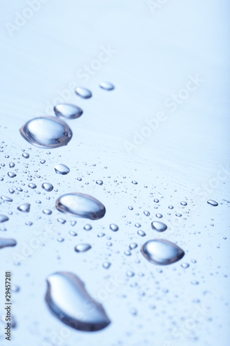 Photo: Background of rain water droplets on blue surface Background of rain water droplets on blue surface
