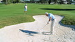 Senior Gentleman Chipping Ball out of Sand Bunker