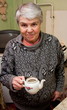 elderly grey woman on a kitchen