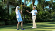 Senior Couple Sinking the Golf Putt