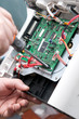 View of a circuit board being repaired.