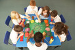 Overhead View Of Schoolchildren Working Together At Desk Overhead View Of Schoolchildren Working Together At Desk
