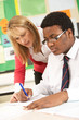 Photo: Teenage Student Working In Classroom With Teacher Teenage Student Working In Classroom With Teacher