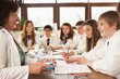 Group Of Teenage Students In Science Class With Tutor