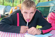 The young guy thinking and writing