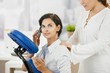Occupied businesswoman getting massage