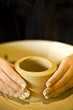 female hands making pottery