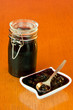 Jar and bowl of blackberry jelly with spoon