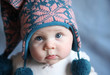 Baby with blue eyes in a winter cap