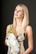 Young beautiful girl with orchid on black background