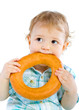 Little baby boy holding a bagel Little baby boy holding a bagel