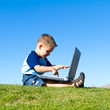 Foto: little boy playing with laptop little boy playing with laptop