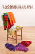Messy clothes on a chair and empty hangers on the background Messy clothes on a chair and empty hangers on the background