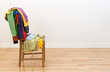 Wooden chair with messy clothes on it Wooden chair with messy clothes on it