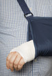 Man with bandaged arm in sling after surgery Man with bandaged arm in sling after surgery