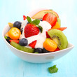 Fruity summer salad in white bowl with yogurt Fruity summer salad in white bowl with yogurt