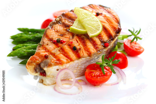 Photo: Grilled salmon with lime, asparagus and cherry tomatoes on white Grilled salmon with lime, asparagus and cherry tomatoes on white