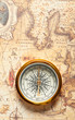 Old compass on ancient map